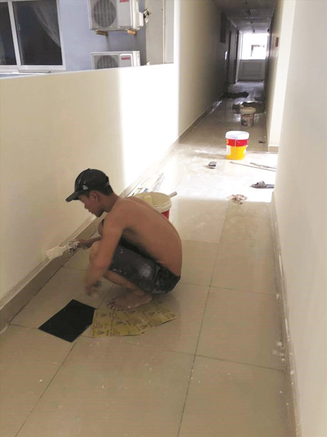 C&ocirc;ng nh&acirc;n đang tiến h&agrave;nh sơn lại h&agrave;nh lang block A v&agrave; B chung cư Carina. Ảnh: Trường Sơn