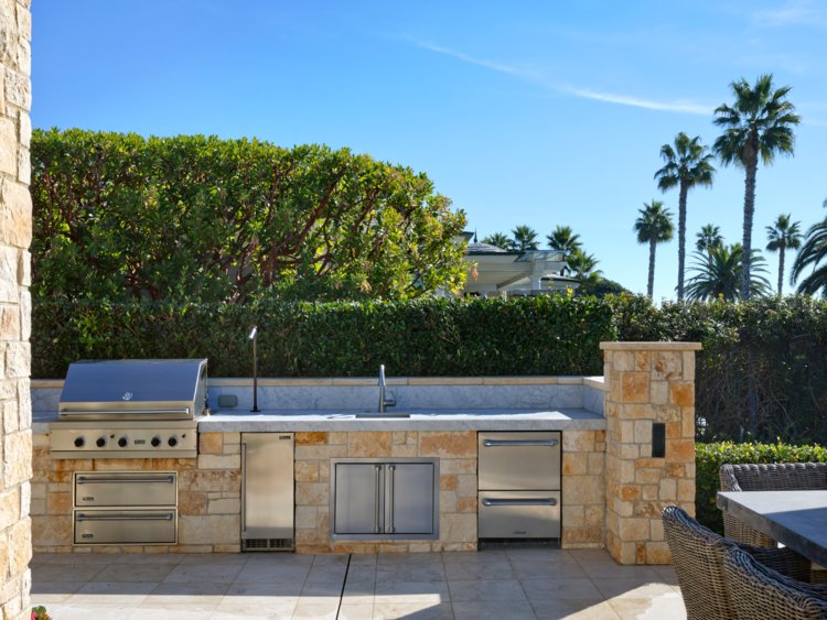 ... and an outdoor kitchen complete with a grill and sink.